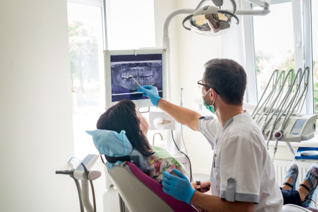 A dentist showing a patient x-ray, Humanizing Technology