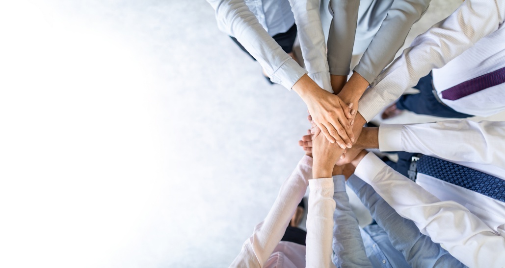  Improving Business Adaptability, A group of people with their hands in a pile