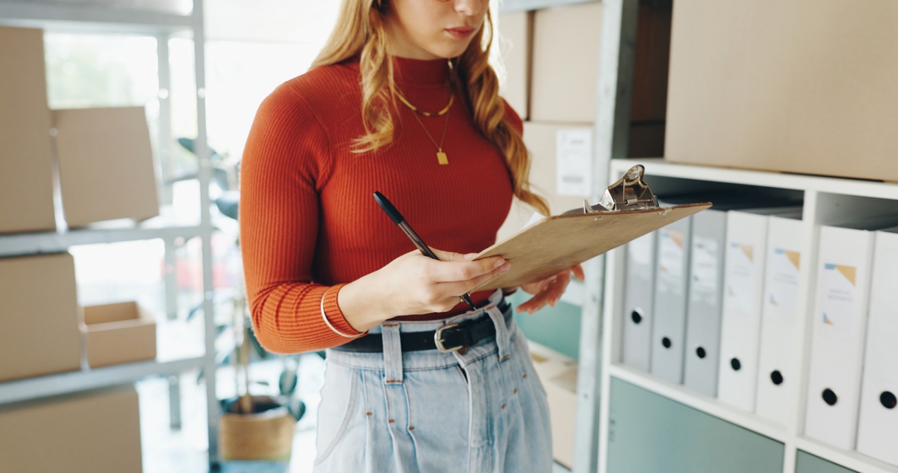 Impact of disorganization, A person in a red shirt holding a clipboard and a pen